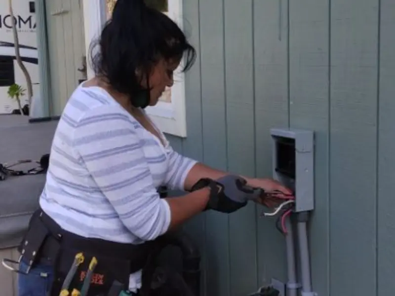 Licensed electrician wiring an exterior subpanel in Flowing Wells